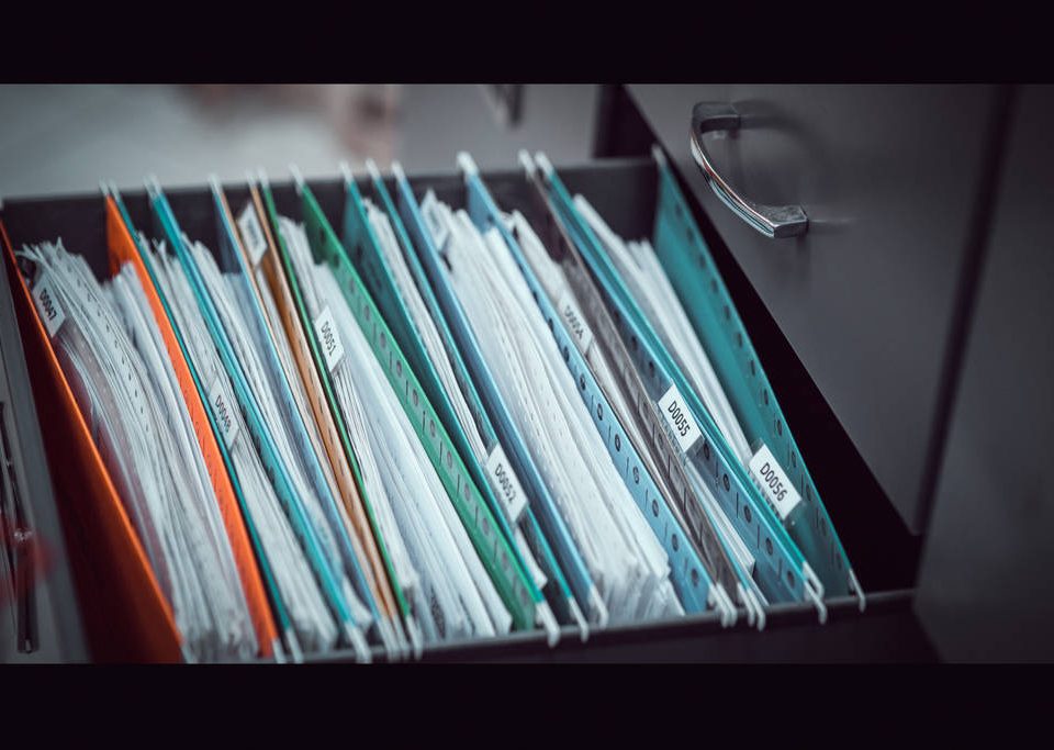 Important owners corporation records and documents in a filing cabinet